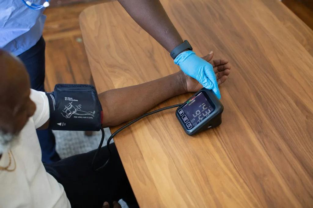 Healthcare provider taking patient blood pressure in clinic