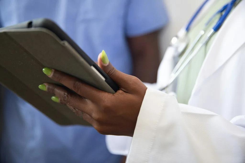 Wellness clinician using tablet during patient care