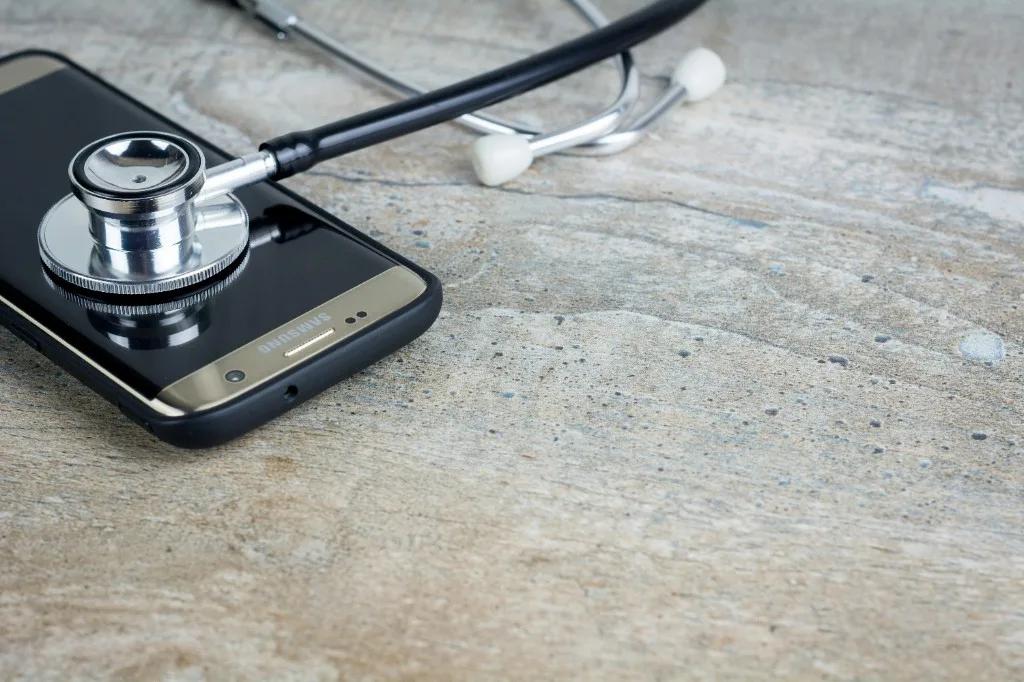 Telehealth wellness consultation with smartphone and stethoscope