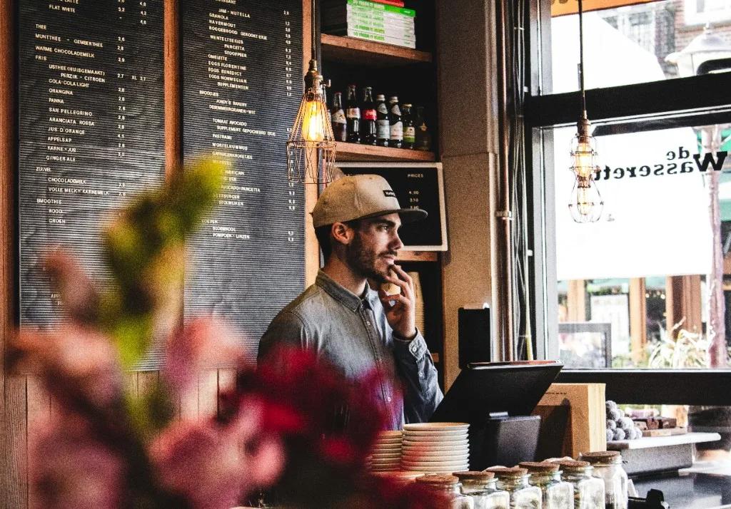 Barista serving customers at a café counter